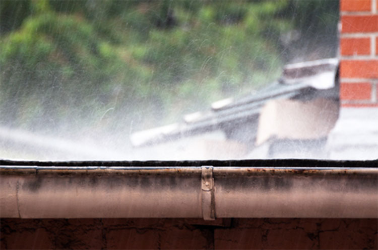 Cleaning eavestrough with Hotsy pressure washer