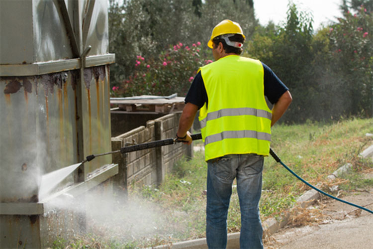 Man following pressure washer safety guidelines