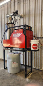 Hotsy-1400-series-industrial-pressure-washer-with-a-bucket-for-detergents-and-cleaning-fluids