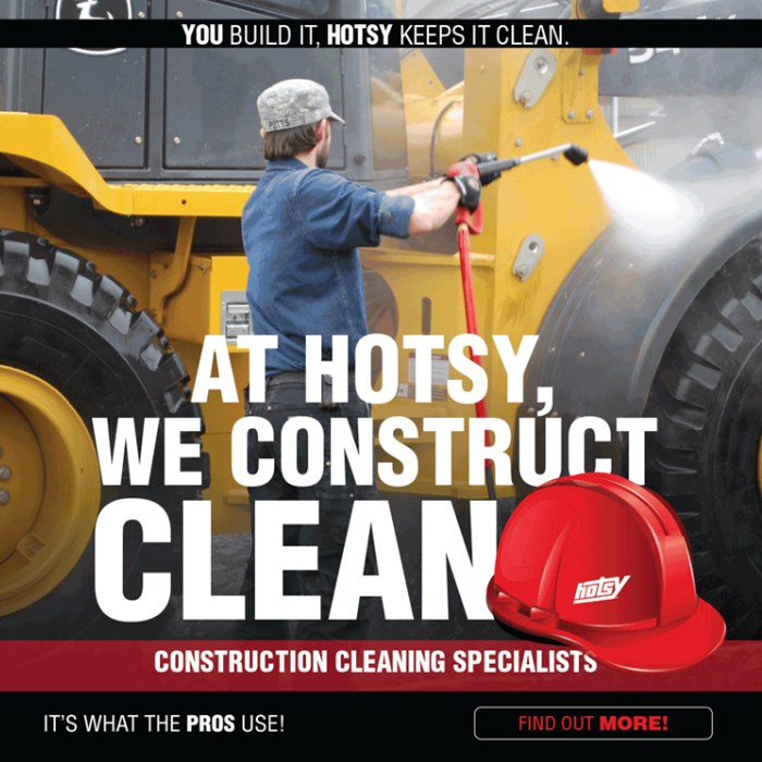 Worker cleaning construction equipment with a Hotsy pressure washer