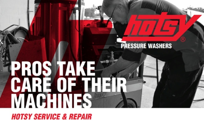 Technician servicing Hotsy pressure washer during maintenance in a repair workshop